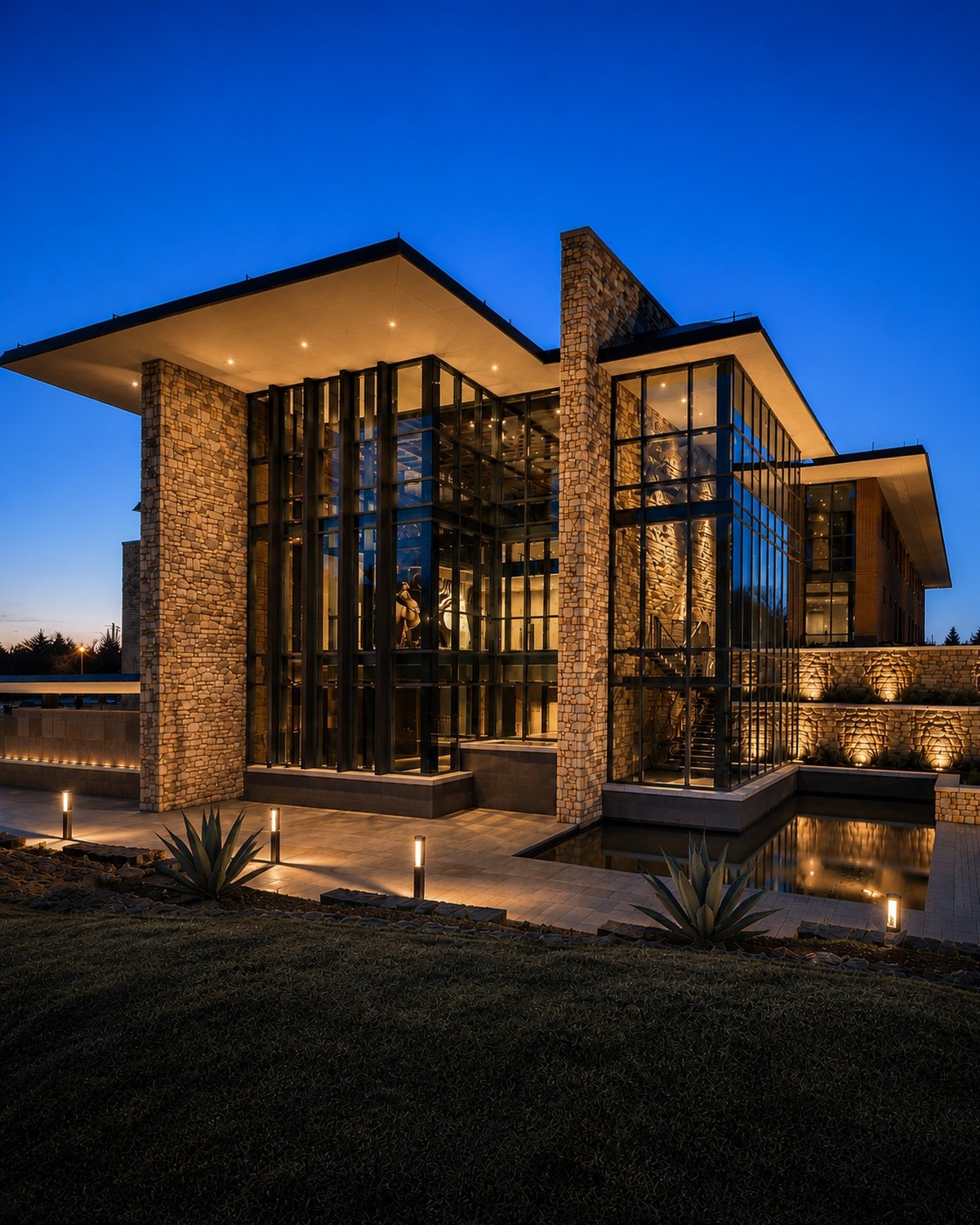 Modern commercial building with stone and glass exterior at dusk